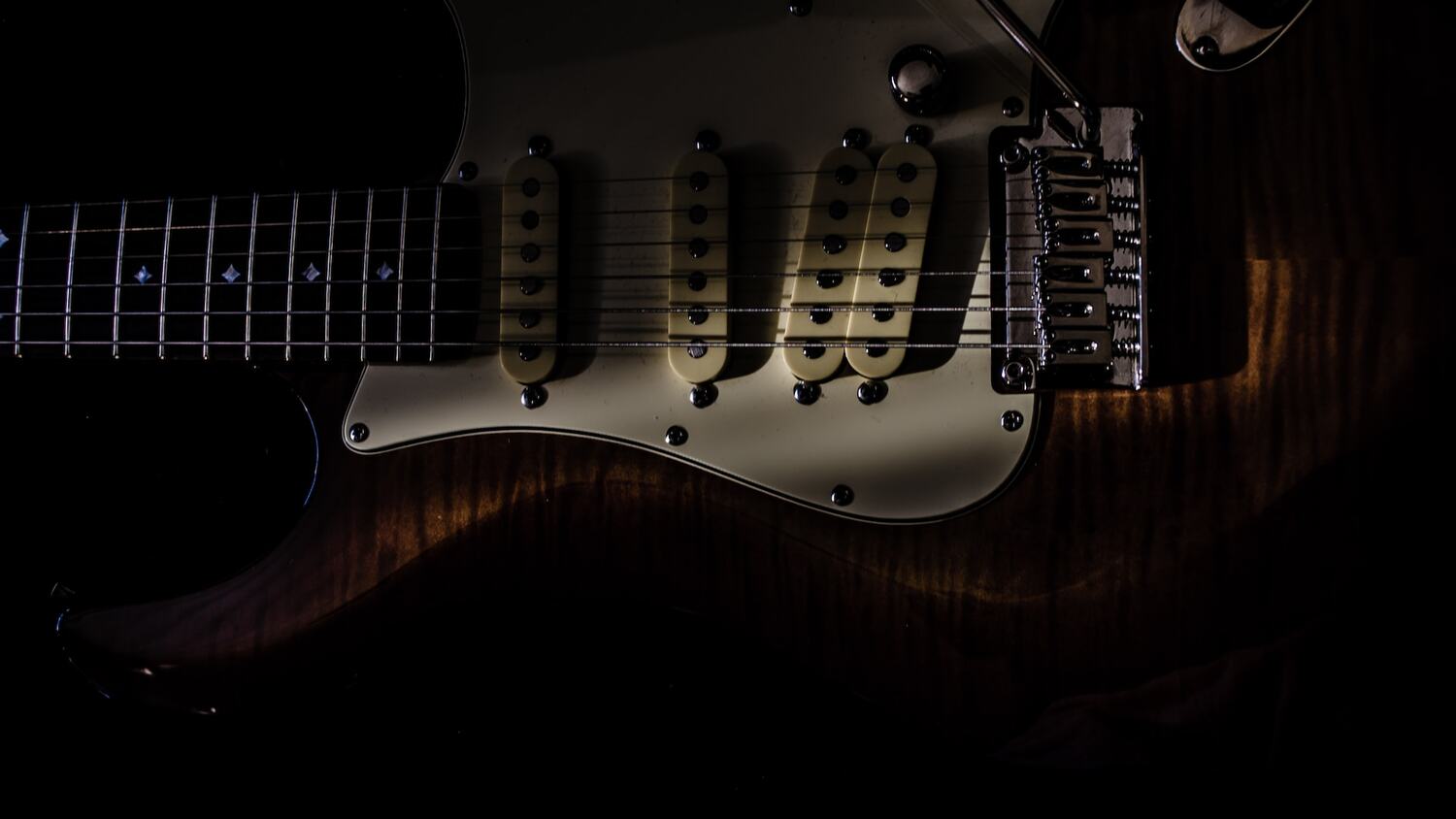 Black guitar under the sunlight